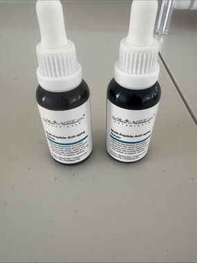 adidas white and black dropper serum bottles